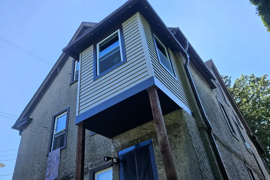 Exterior siding and upper-story addition on a house