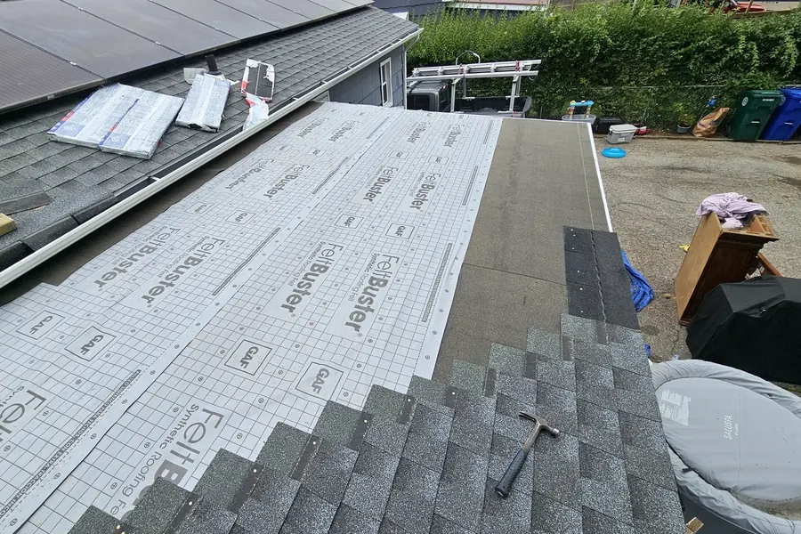 Roofing underlayment and new shingles during installation