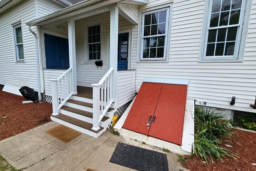 White front entrance porch with railings and steps