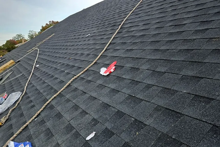 Close view of asphalt shingle installation in progress